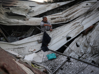 A Palestinian man inspects the damage in the aftermath of an Israeli strike on a tent camp in Khan Younis, Gaza Strip, on December 5, 2024,...