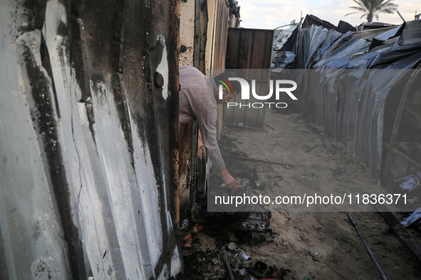 A Palestinian man inspects the damage in the aftermath of an Israeli strike on a tent camp in Khan Younis, Gaza Strip, on December 5, 2024,...