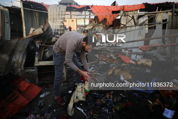 A Palestinian man inspects the damage in the aftermath of an Israeli strike on a tent camp in Khan Younis, Gaza Strip, on December 5, 2024,...