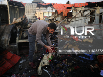 A Palestinian man inspects the damage in the aftermath of an Israeli strike on a tent camp in Khan Younis, Gaza Strip, on December 5, 2024,...