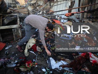 A Palestinian man inspects the damage in the aftermath of an Israeli strike on a tent camp in Khan Younis, Gaza Strip, on December 5, 2024,...