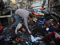 A Palestinian man inspects the damage in the aftermath of an Israeli strike on a tent camp in Khan Younis, Gaza Strip, on December 5, 2024,...