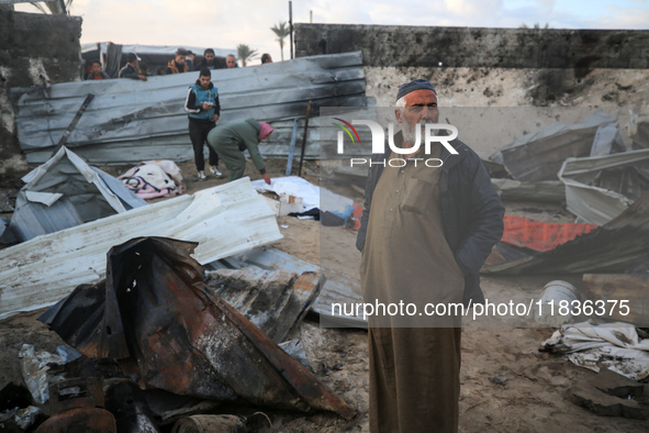 A Palestinian man inspects the damage in the aftermath of an Israeli strike on a tent camp in Khan Younis, Gaza Strip, on December 5, 2024,...