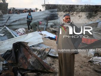 A Palestinian man inspects the damage in the aftermath of an Israeli strike on a tent camp in Khan Younis, Gaza Strip, on December 5, 2024,...