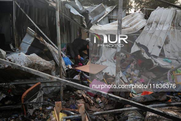 A Palestinian man inspects the damage in the aftermath of an Israeli strike on a tent camp in Khan Younis, Gaza Strip, on December 5, 2024,...