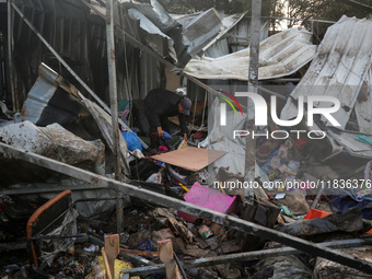 A Palestinian man inspects the damage in the aftermath of an Israeli strike on a tent camp in Khan Younis, Gaza Strip, on December 5, 2024,...