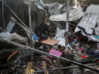 A Palestinian man inspects the damage in the aftermath of an Israeli strike on a tent camp in Khan Younis, Gaza Strip, on December 5, 2024,...