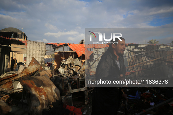 Palestinians inspect the damage in the aftermath of an Israeli strike on a tent camp in Khan Younis, Gaza Strip, on December 5, 2024, amid t...