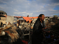 Palestinians inspect the damage in the aftermath of an Israeli strike on a tent camp in Khan Younis, Gaza Strip, on December 5, 2024, amid t...