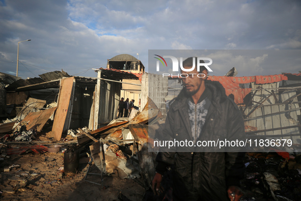 Palestinians inspect the damage in the aftermath of an Israeli strike on a tent camp in Khan Younis, Gaza Strip, on December 5, 2024, amid t...