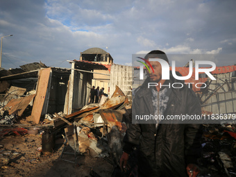 Palestinians inspect the damage in the aftermath of an Israeli strike on a tent camp in Khan Younis, Gaza Strip, on December 5, 2024, amid t...