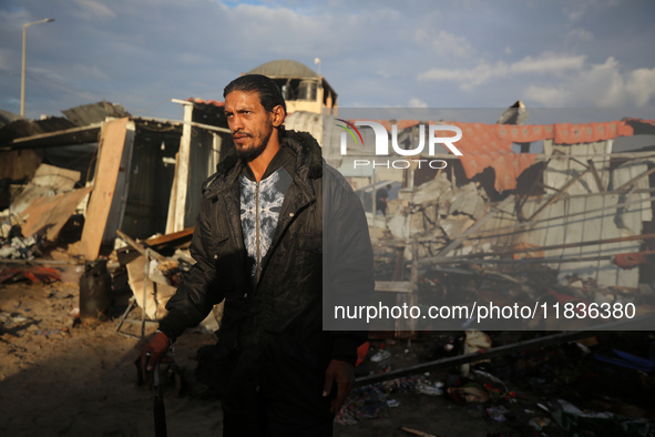 A Palestinian man inspects the damage in the aftermath of an Israeli strike on a tent camp in Khan Younis, Gaza Strip, on December 5, 2024,...