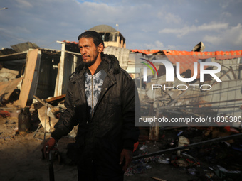 A Palestinian man inspects the damage in the aftermath of an Israeli strike on a tent camp in Khan Younis, Gaza Strip, on December 5, 2024,...