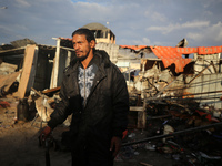 A Palestinian man inspects the damage in the aftermath of an Israeli strike on a tent camp in Khan Younis, Gaza Strip, on December 5, 2024,...