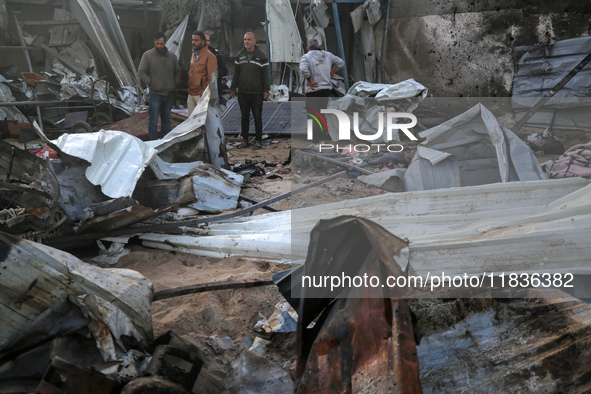 Palestinians inspect the damage in the aftermath of an Israeli strike on a tent camp in Khan Younis, Gaza Strip, on December 5, 2024, amid t...