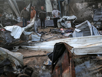 Palestinians inspect the damage in the aftermath of an Israeli strike on a tent camp in Khan Younis, Gaza Strip, on December 5, 2024, amid t...