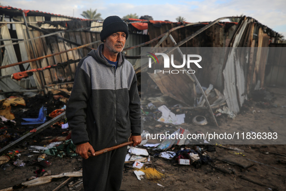 A Palestinian man inspects the damage in the aftermath of an Israeli strike on a tent camp in Khan Younis, Gaza Strip, on December 5, 2024,...