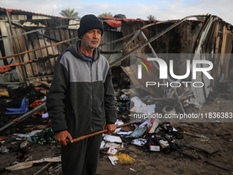 A Palestinian man inspects the damage in the aftermath of an Israeli strike on a tent camp in Khan Younis, Gaza Strip, on December 5, 2024,...