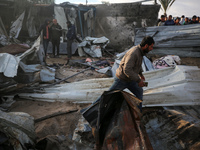 Palestinians inspect the damage in the aftermath of an Israeli strike on a tent camp in Khan Younis, Gaza Strip, on December 5, 2024, amid t...