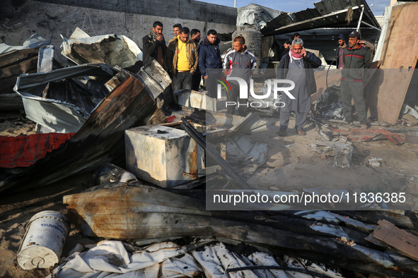 Palestinians inspect the damage in the aftermath of an Israeli strike on a tent camp in Khan Younis, Gaza Strip, on December 5, 2024, amid t...