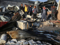 Palestinians inspect the damage in the aftermath of an Israeli strike on a tent camp in Khan Younis, Gaza Strip, on December 5, 2024, amid t...