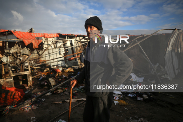 A Palestinian man inspects the damage in the aftermath of an Israeli strike on a tent camp in Khan Younis, Gaza Strip, on December 5, 2024,...