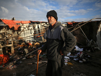 A Palestinian man inspects the damage in the aftermath of an Israeli strike on a tent camp in Khan Younis, Gaza Strip, on December 5, 2024,...