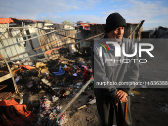 A Palestinian man inspects the damage in the aftermath of an Israeli strike on a tent camp in Khan Younis, Gaza Strip, on December 5, 2024,...