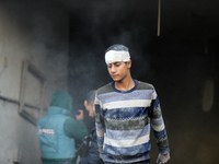 People stand on the rubble of a building after an Israeli strike in Nuseirat, Gaza Strip, on December 5, 2024, as the war between Israel and...