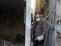 People stand on the rubble of a building after an Israeli strike in Nuseirat, Gaza Strip, on December 5, 2024, as the war between Israel and...