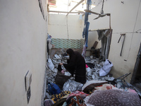 People stand on the rubble of a building after an Israeli strike in Nuseirat, Gaza Strip, on December 5, 2024, as the war between Israel and...