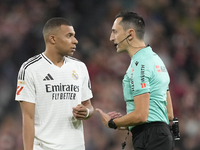 Kylian Mbappe centre-forward of Real Madrid and France talks with referee Jose Maria Sanchez Martinez during the La Liga match between Athle...