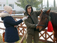 In Kosiv, Ukraine, on December 2, 2024, a worker speaks to a journalist about the Hutsul pony, also known as the Hucul pony or Carpathian po...