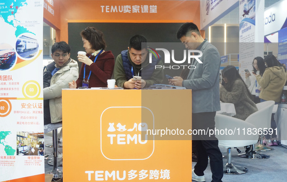 Visitors visit the stand of Pinduoduo's Temu at a fashion exhibition in Hangzhou, Zhejiang province, China, on December 5, 2024. 