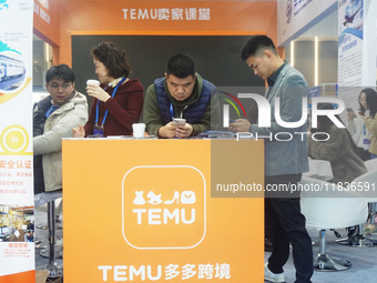 Visitors visit the stand of Pinduoduo's Temu at a fashion exhibition in Hangzhou, Zhejiang province, China, on December 5, 2024. (