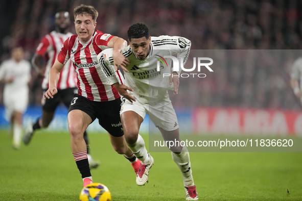 Jude Bellingham central midfield of Real Madrid and England and Mikel Jauregizar central midfield of Athletic Club and Spain compete for the...