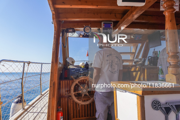 The helmsman of a tourist ship is seen in Side, Turkey, on November 7, 2024. 