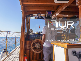 The helmsman of a tourist ship is seen in Side, Turkey, on November 7, 2024. (