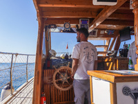 The helmsman of a tourist ship is seen in Side, Turkey, on November 7, 2024. (