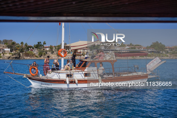 A ship with tourists travels along the Mediterranean coast in Side, Turkey, on November 7, 2024 