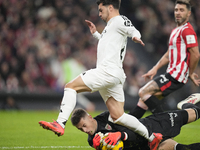 Brahim Diaz attacking midfield of Real Madrid and Spain and Julen Agirrezabala goalkeeper of Athletic Club and Spain compete for the ball du...