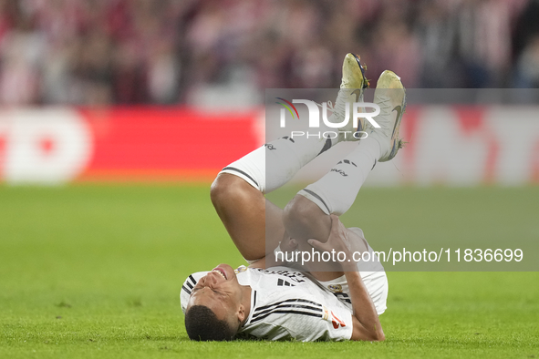 Kylian Mbappe centre-forward of Real Madrid and France lies injured on the pitch during the La Liga match between Athletic Club and Real Mad...