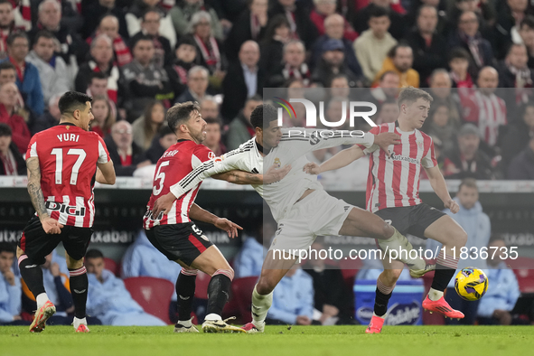 Jude Bellingham central midfield of Real Madrid and England surrounded by Athletci players during the La Liga match between Athletic Club an...