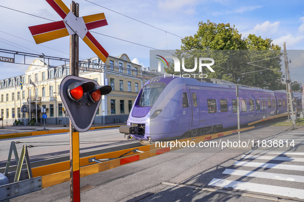 An SJ Swedish railway company train crosses the level crossing in Ystad, Sweden, on August 4, 2024. 