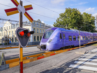 An SJ Swedish railway company train crosses the level crossing in Ystad, Sweden, on August 4, 2024. (