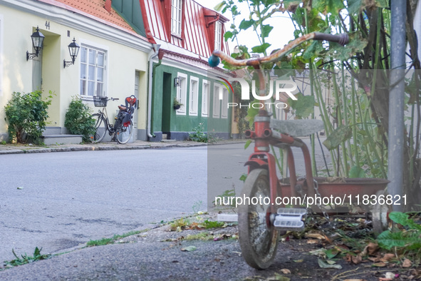 An old town street with bicycles parked in front of buildings is seen in Ystad, Sweden, on August 4, 2024. 