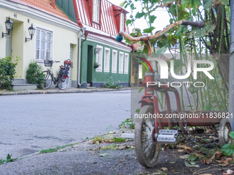 An old town street with bicycles parked in front of buildings is seen in Ystad, Sweden, on August 4, 2024. (