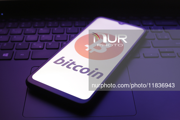 The Bitcoin logo appears on the screen of a smartphone in Reno, United States, on December 5, 2024. 