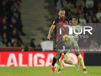 Vedat Muriqi centre-forward of Mallorca and Kosovo and Jules Kounde centre-back of Barcelona and France compete for the ball during the La L...