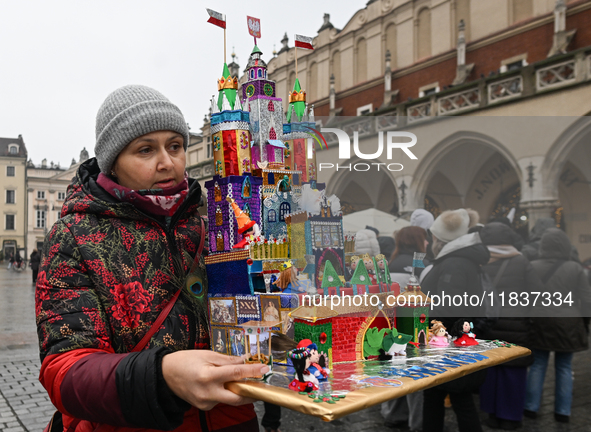 KRAKOW, POLAND - DECEMBER 05:
A contestant presents their handcrafted Nativity Scene at Krakow's Main Square during the 82nd Nativity Scene...